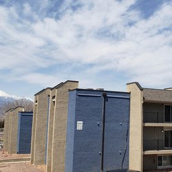 Buildings featuring balconies with a view of the mountains in the background at Parc at Prairie Grass, located in Colorado Springs, CO