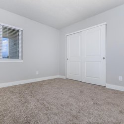 Carpeted second bedroom with a balcony view and large closet at Parc at Prairie Grass, located in Colorado Springs, CO